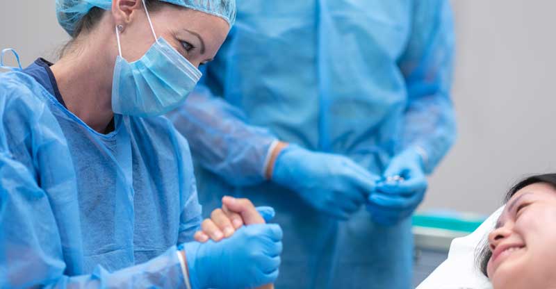 surgeon comforting patient